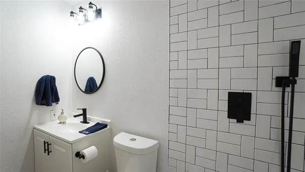 a bathroom with a sink toilet a mirror and vanity