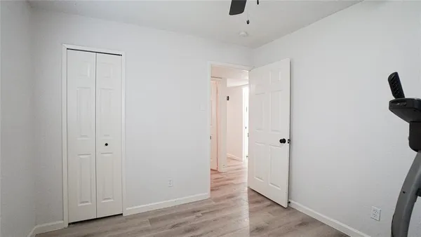 a view of a room with wooden floor