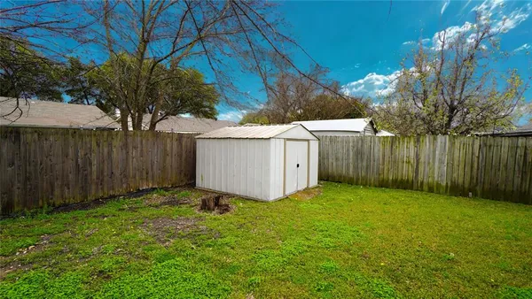 a view of backyard with tub and trees