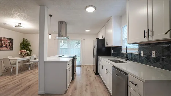 a kitchen with a sink stove and cabinets