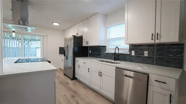 a kitchen with a sink stove and refrigerator
