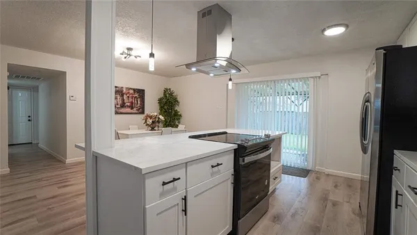 a kitchen with a sink and refrigerator