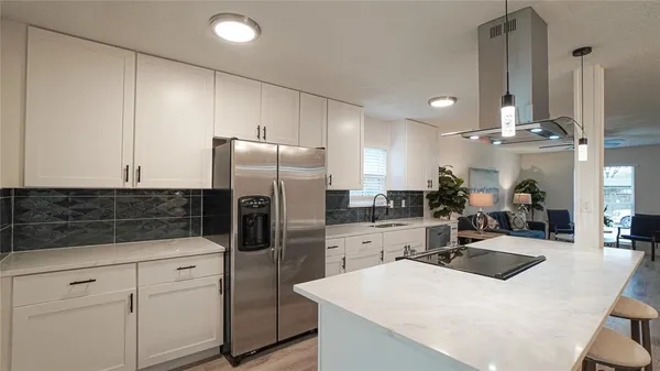 a kitchen with refrigerator and cabinets