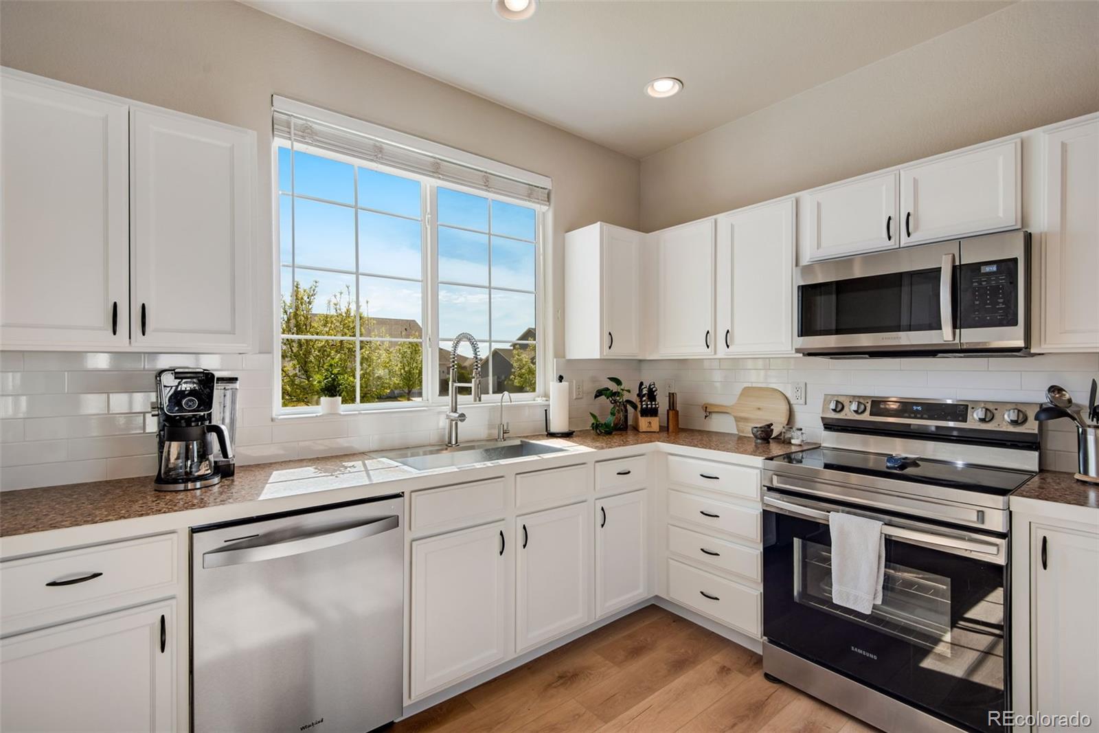 7035 McClellan Road Wellington, CO 80549 - Photo 7 of 43 a kitchen with a sink stove oven and window