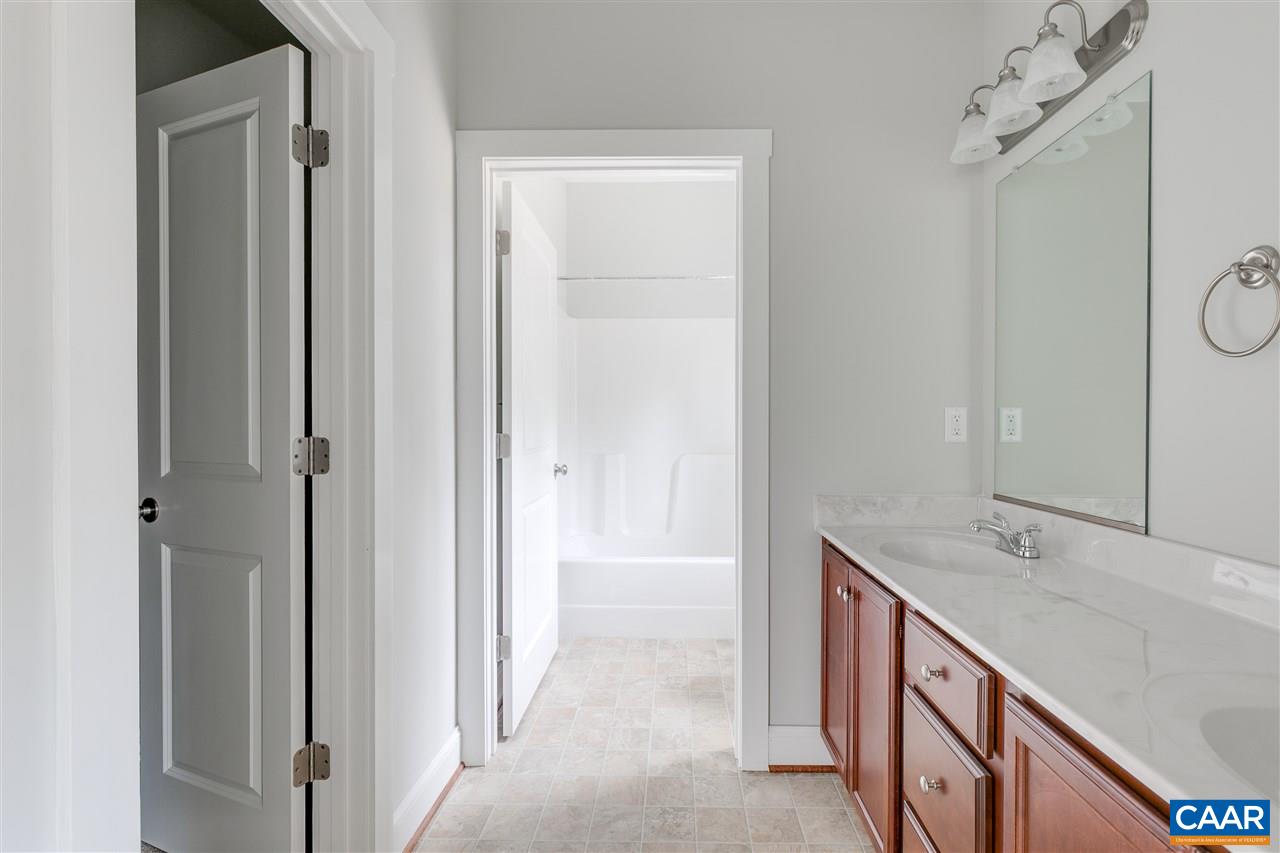 374 Winding Ridge Way Bumpass, VA 23024 - Photo 12 of 24 a spacious bathroom with a double vanity sink a mirror and a bathtub