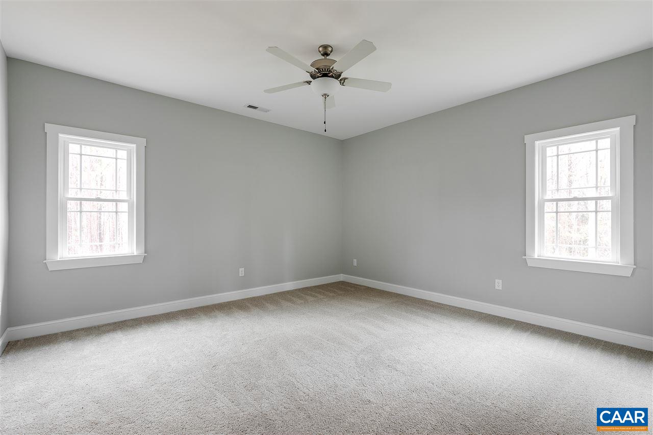 374 Winding Ridge Way Bumpass, VA 23024 - Photo 14 of 24 an empty room with a window and a ceiling fan