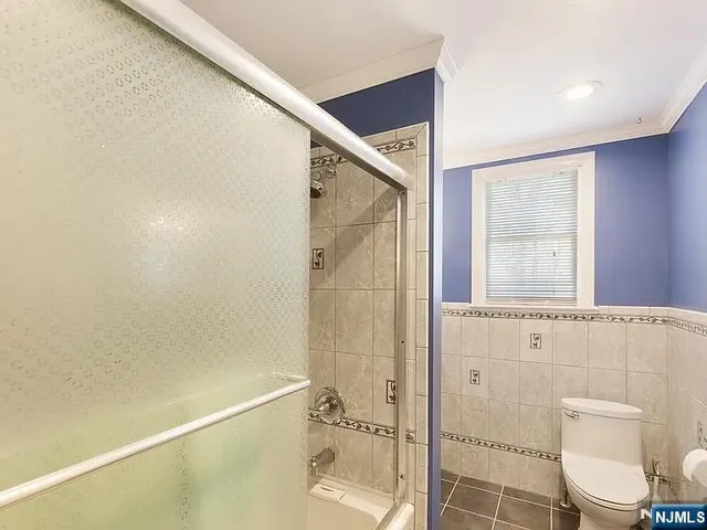 a bathroom with a shower and toilet