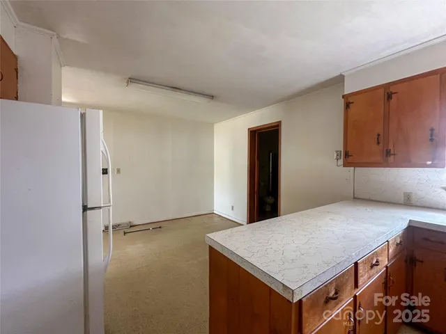 a kitchen with a table and chairs