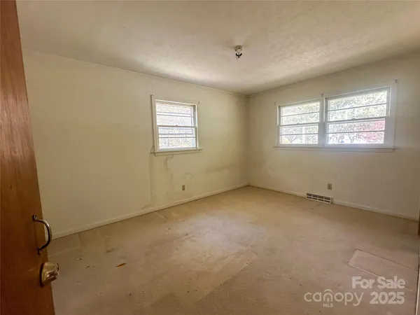 an empty room with a empty space and windows