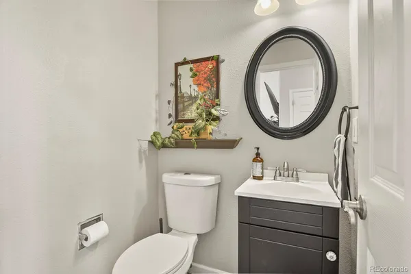 a bathroom with a toilet a sink and a mirror