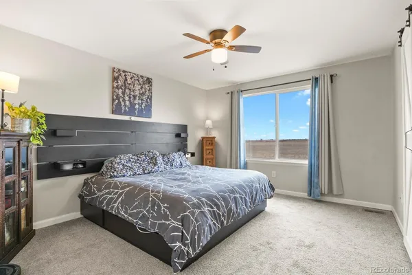 a bedroom with a large bed and a window