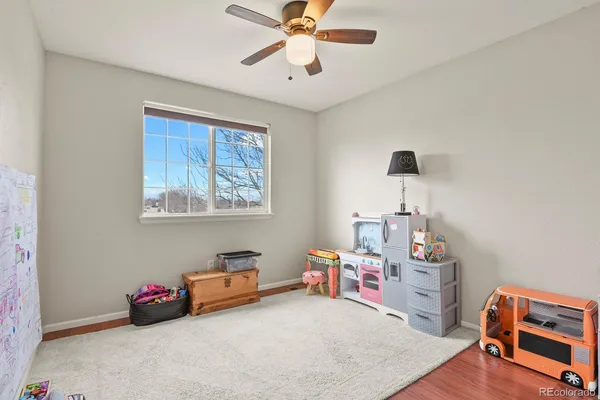 a view of a room with toys and wooden floor