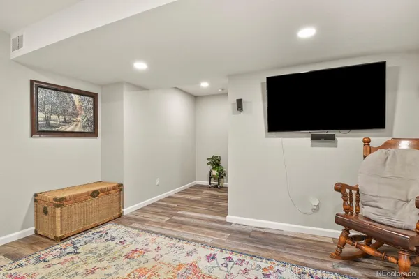 a living room with furniture a rug and a fireplace