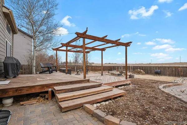 a view of a house with backyard and a sitting area