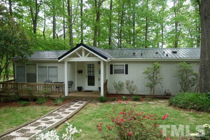 285 Kerr Lake Road Henderson, NC 27537 - Photo 1 of 25 a front view of a house with garden