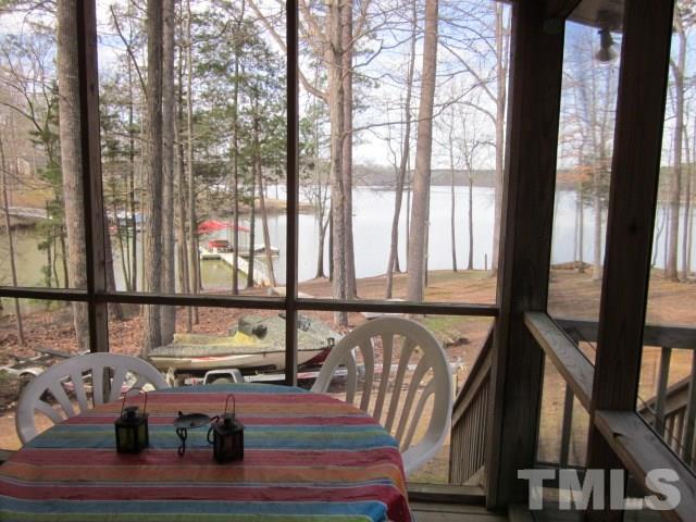 285 Kerr Lake Road Henderson, NC 27537 - Photo 11 of 25 a living room with furniture and a floor to ceiling window