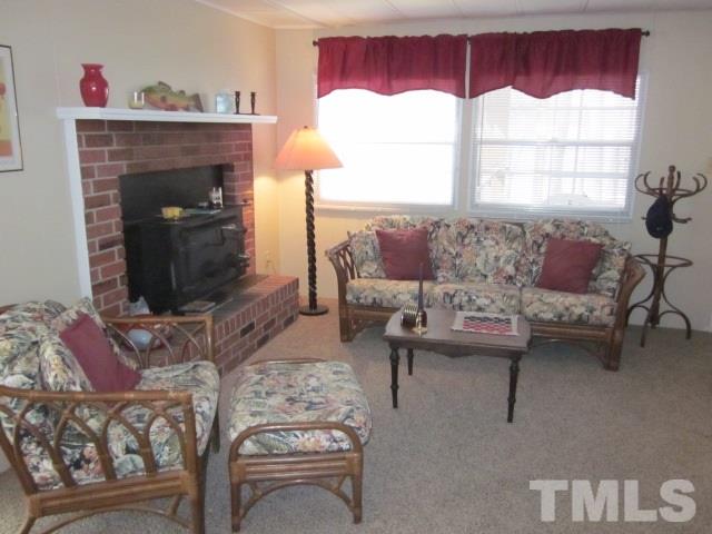 285 Kerr Lake Road Henderson, NC 27537 - Photo 12 of 25 a living room with furniture and a fireplace