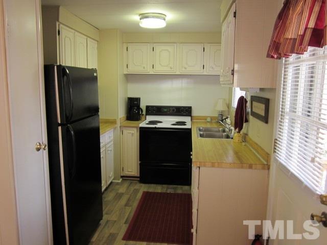 285 Kerr Lake Road Henderson, NC 27537 - Photo 15 of 25 a kitchen with a refrigerator stove and cabinets