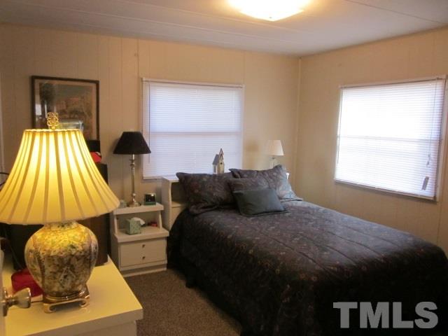 285 Kerr Lake Road Henderson, NC 27537 - Photo 17 of 25 a bedroom with a bed and a window