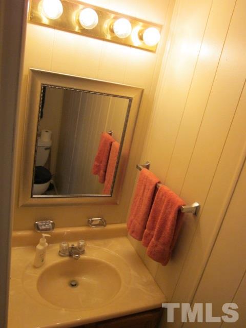 285 Kerr Lake Road Henderson, NC 27537 - Photo 18 of 25 a bathroom with a sink and mirror