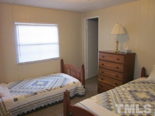 285 Kerr Lake Road Henderson, NC 27537 - Photo 19 of 25 a bedroom with a bed and a window