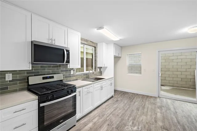 a kitchen with a stove and a microwave
