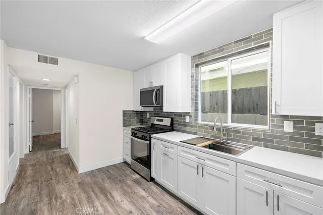 a kitchen with a sink stove and refrigerator