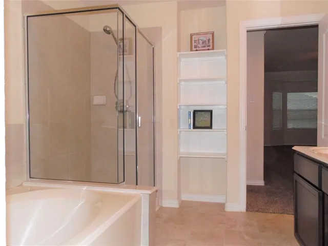 a white bath tub sitting next to a shower