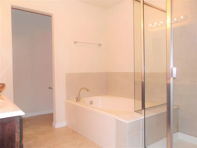 a view of a hallway with closet and bathroom