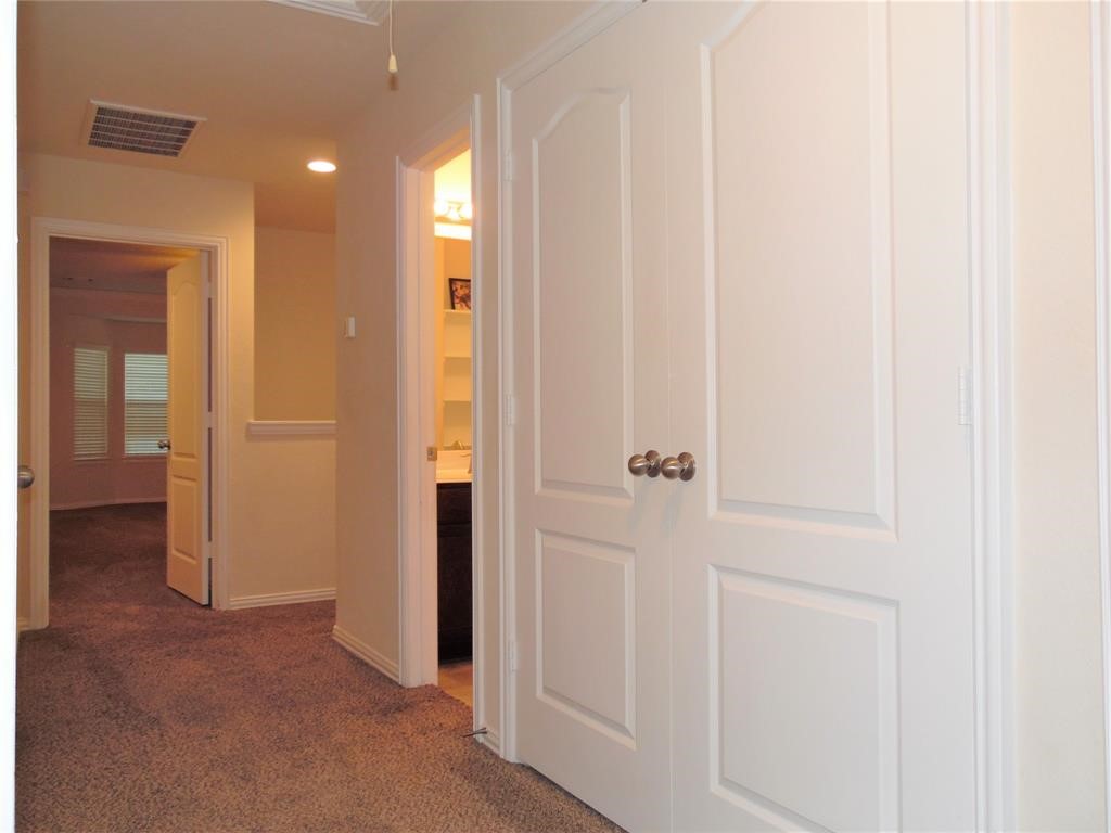 5106 Gable Lane Houston, TX 77066 - Photo 24 of 39 a view of a hallway with closet and bathroom