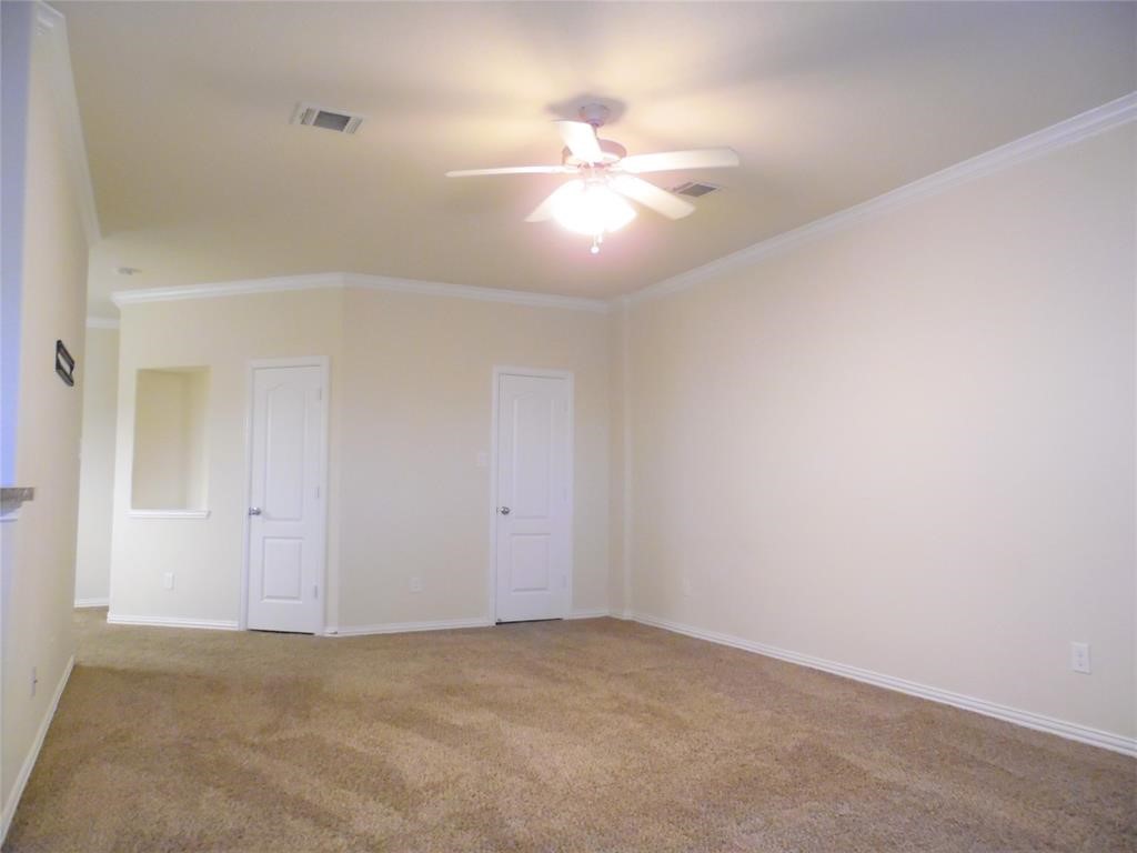 5106 Gable Lane Houston, TX 77066 - Photo 5 of 39 an empty room with a chandelier fan and windows