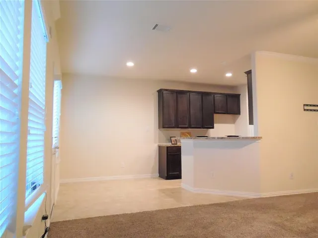 a view of kitchen with stainless steel appliances refrigerator sink and microwave