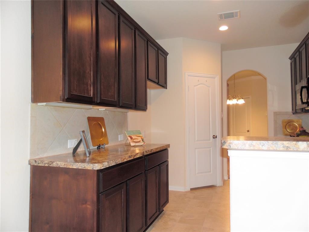 5106 Gable Lane Houston, TX 77066 - Photo 10 of 39 a kitchen with granite countertop a sink a stove and cabinets