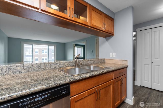a kitchen with granite countertop a sink and a window