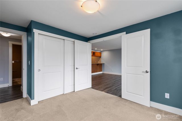 an empty room with closet and a bathroom