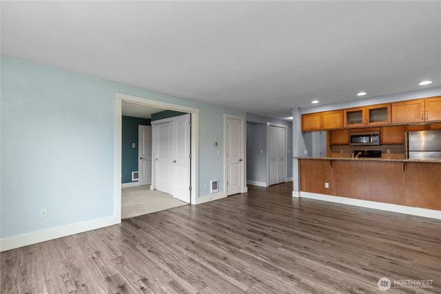a view of kitchen with a sink and cabinets
