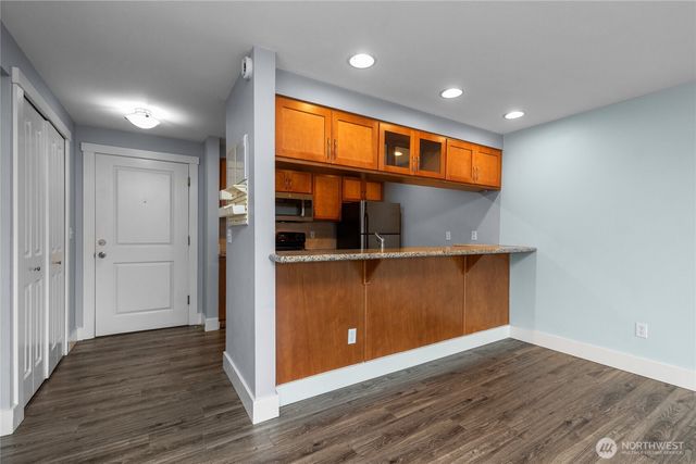 a view of kitchen and wooden floor