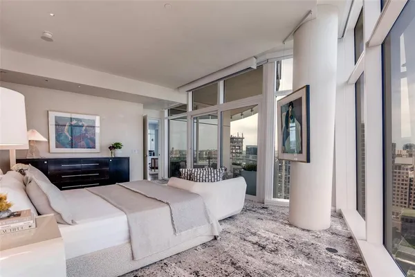 a bedroom with a large bed and a window