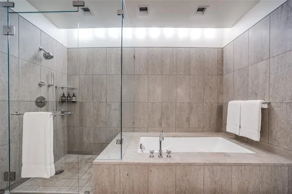 a bathroom with a tub a toilet and a sink