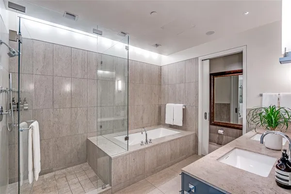 a spacious bathroom with a tub shower and sink