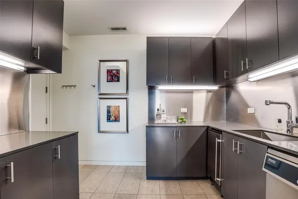 a kitchen with a sink and cabinets