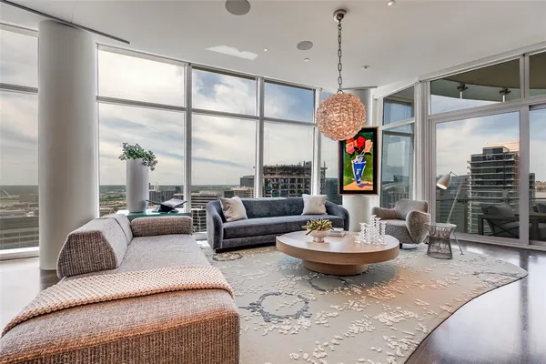 a living room with fireplace furniture and a large window