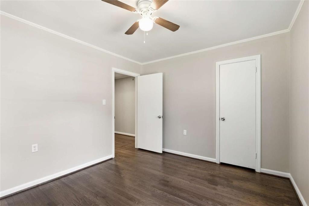 229 Hilltop Lane Toccoa, GA 30577 - Photo 14 of 30 an empty room with wooden floor ceiling fan and windows