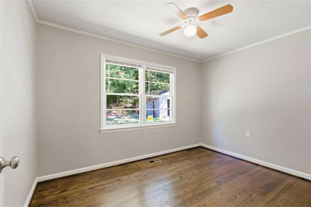 229 Hilltop Lane Toccoa, GA 30577 - Photo 16 of 30 a view of an empty room with wooden floor and a window