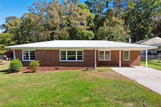 a front view of house with yard and green space