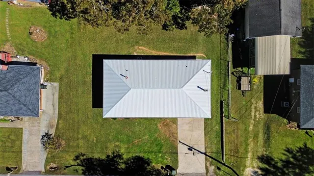 an aerial view of a house with a yard