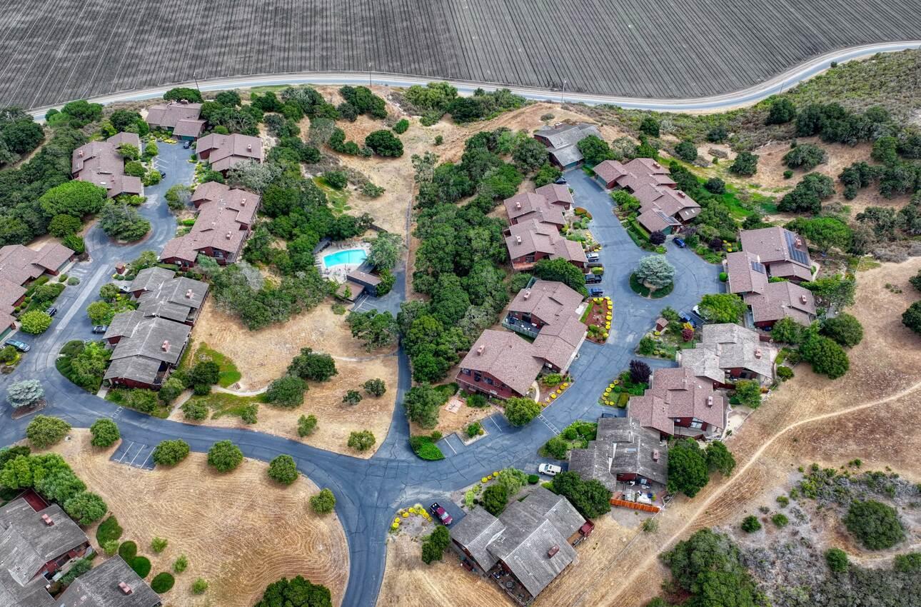 an aerial view of a house with a yard and garden