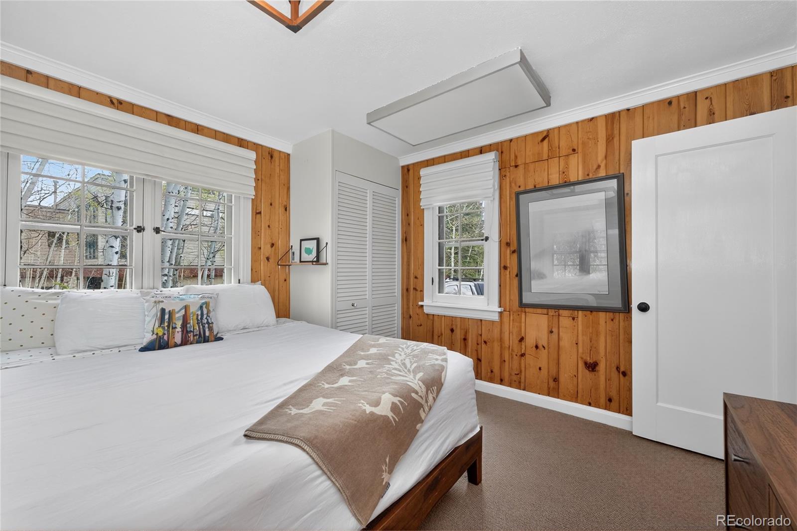 327 Vasquez Road, Unit E1 Winter Park, CO 80482 - Photo 22 of 43 a bedroom with a large bed and a window