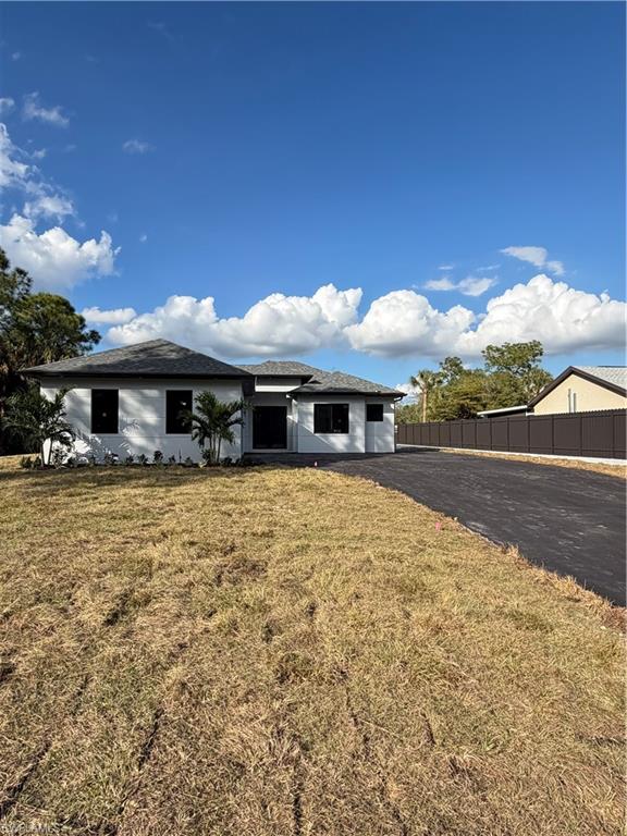 2963 18th Avenue Northeast Naples, FL 34120 - Photo 2 of 10 View of front facade with a shingled roof