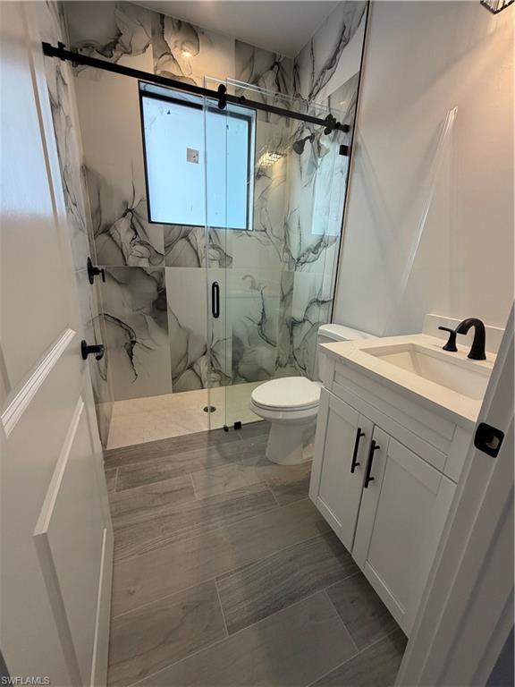 2963 18th Avenue Northeast Naples, FL 34120 - Photo 5 of 10 Full bath featuring a marble finish shower and vanity